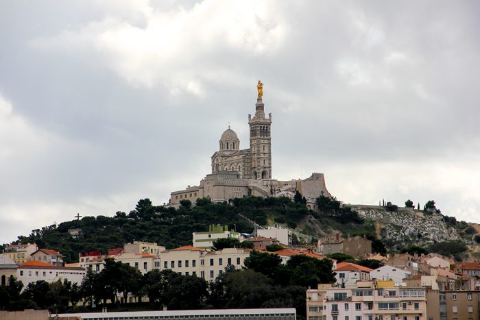 A View Of Notre Dame De La Garde From The Old Porte In Marseille In France