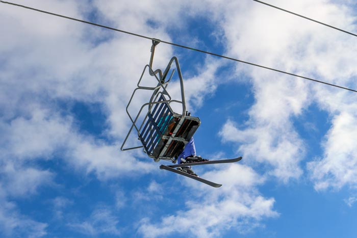Skier Sitting On A Chairlift