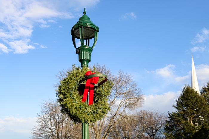 A Street Lamp Decorated For Christmas On Elm Street