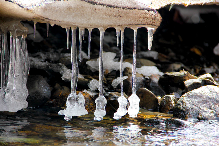 Dripping Ice Hanging Over The Water