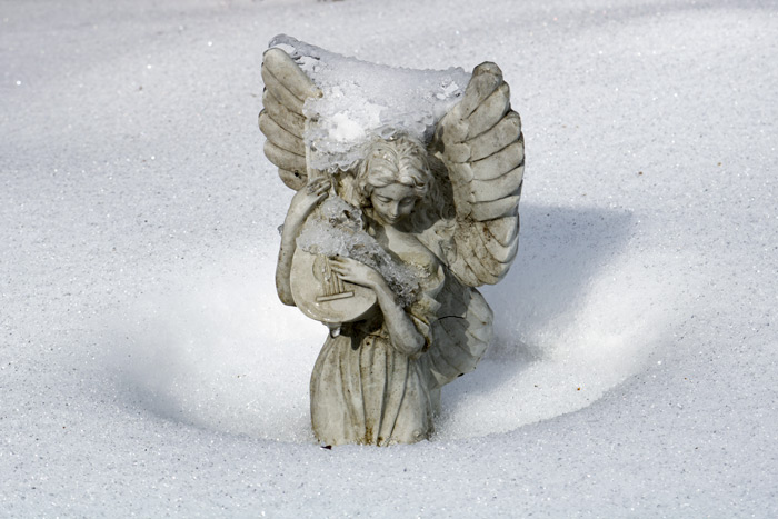 An Ice Covered Garden Angel Statue