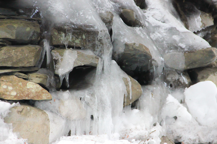 A Rock Wall Covered In Ice