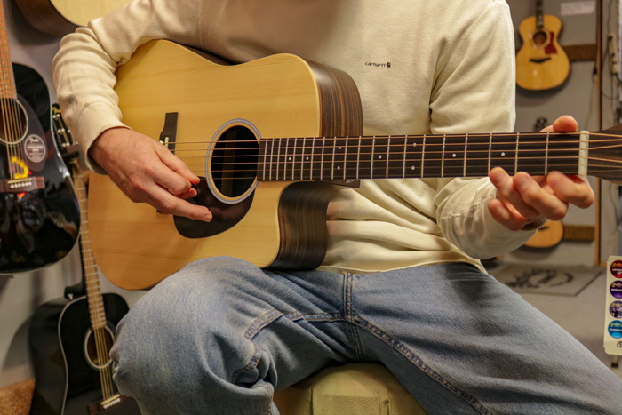 Close up Of Male Hands Playing Guitar