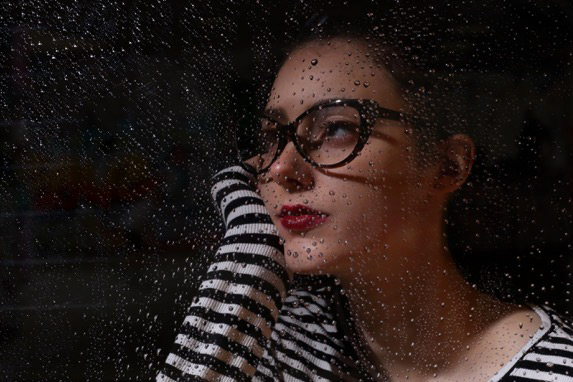 Female Model With A Rain Covered Window