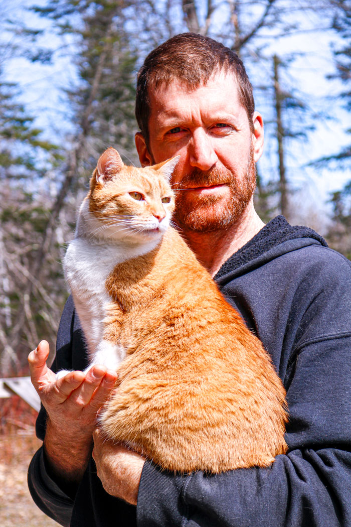Redheaded Man Holding Orange Cat