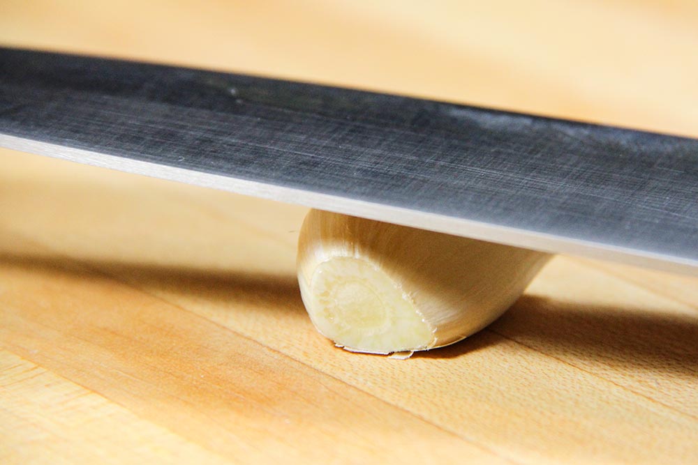 Pounding Chef's Knife on Garlic Clove