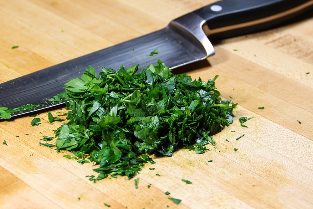 Pile of Chopped Fresh Parsley With Chefs Knife